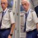 Homem com uniforme de piloto é abordado por policial dentro de avião, expressão surpresa