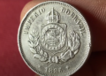 Moeda de 50 réis de 1886, mostrando o escudo do Império do Brasil.