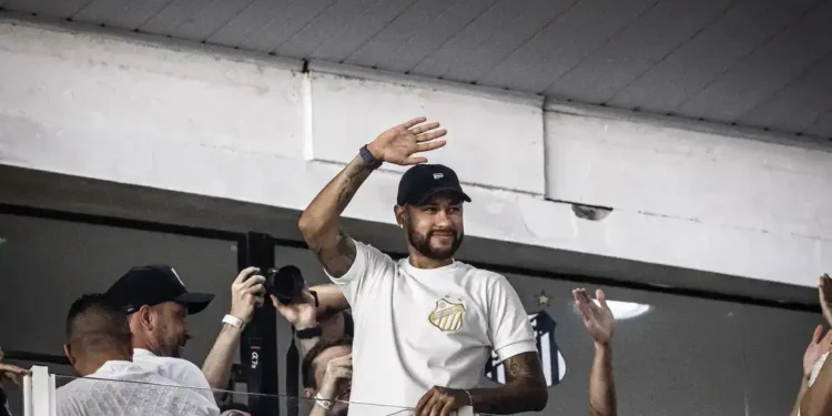 Neymar Jr. acenando para os fãs durante evento no estádio.