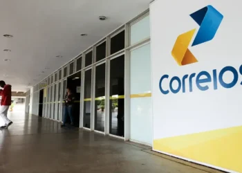 Fachada de uma agência dos Correios com o logo visível.