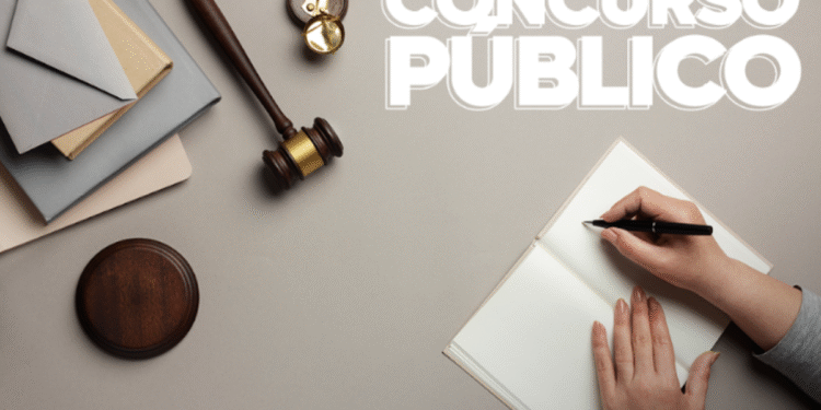 Pessoa escrevendo em caderno ao lado de martelo da justiça, simbolizando estudo para concurso público do TJ SP.