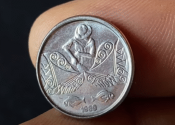 Moeda de 5 centavos do Pescador de 1989 sendo exibida entre os dedos
