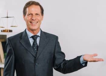 Advogado sorridente de terno com balança da justiça representando oportunidades em concursos jurídicos