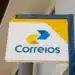 Placa com o logo dos Correios Brasil contendo setas azul e amarela