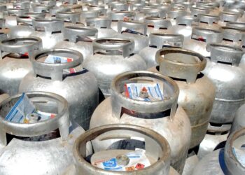 Imagem de diversos botijões de gás empilhados, com destaque para o novo programa 'Gás do Povo', que estabelece um limite anual de botijões grátis.