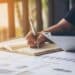 Estudante fazendo anotações em um caderno, priorizando tarefas e organizando estudos para manter o equilíbrio entre trabalho e vida pessoal.