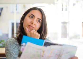 Jovem ponderando sobre perguntas essenciais para descobrir qual é sua profissão ideal e fazer escolha de carreira acertada