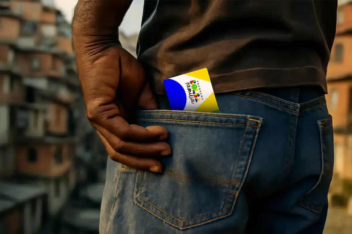 Cartão do Programa Família no bolso de calça jeans Mão masculina colocando cartão colorido do Programa Família no bolso traseiro de calça jeans azul