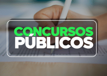 Mão escrevendo em prova de concurso público com destaque para texto "Concursos Públicos".