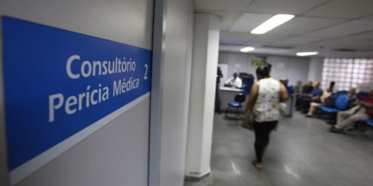 Pessoas aguardam atendimento em consultório de perícia médica do INSS durante mutirão nacional.