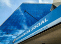 Fachada moderna em vidro azul do edifício sede da Previdência Social com letreiro em destaque