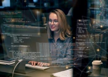 Profissional de tecnologia trabalhando com códigos e inteligência artificial em telas futuristas