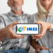 Aposentados acessando portal do INSS em smartphone para verificar mudanças no crédito consignado