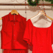 Roupas vermelhas penduradas em cabideiro decorado para o Natal.