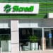 Fachada moderna da agência Sicredi com painéis verdes e logo iluminado em branco e verde