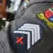 Emblema da Polícia Militar do Rio Grande do Norte mostrando a insígnia de sargento e detalhes do uniforme com o brasão do estado.