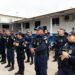 Grupo de guardas municipais em uniformes azuis durante formação ao ar livre em área institucional.