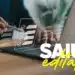Mão segurando caneta interagindo com notebook e checklist digital flutuante sobre a mesa