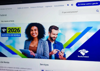 Pessoas usando tablet e smartphone acessam site da Receita Federal com banner do Imposto de Renda 2026