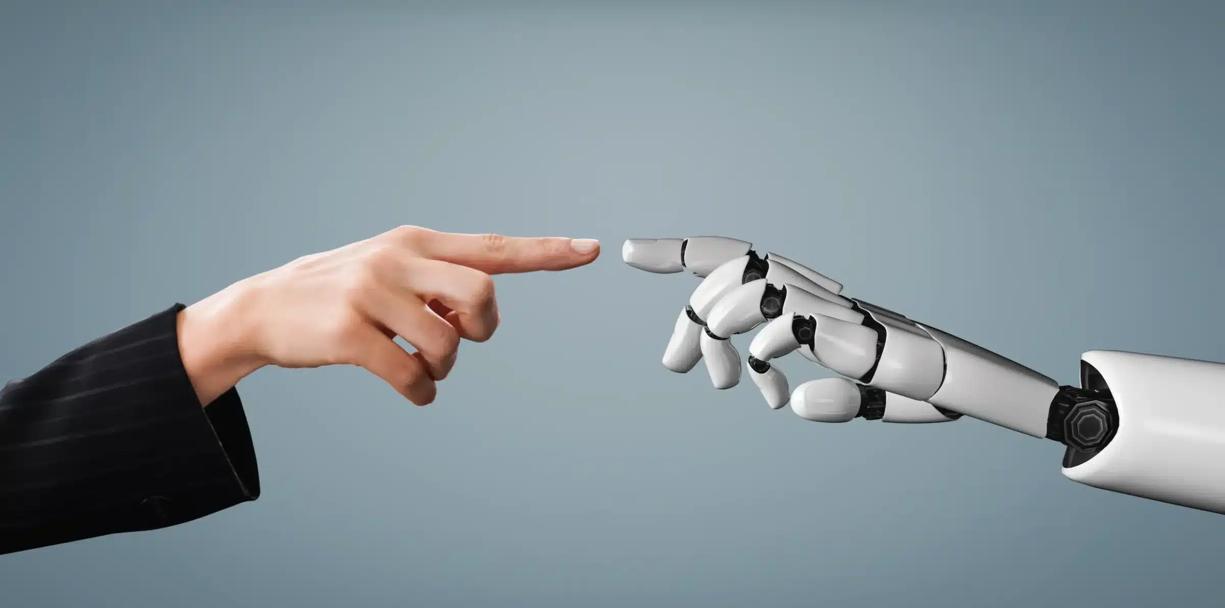 Integração entre Habilidades Humanas e Inteligência Artificial Mão humana e mão robótica se tocando, simbolizando a união entre habilidades humanas e inteligência artificial no setor tecnológico.