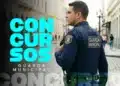 Guarda municipal masculino de perfil com rádio comunicador em área urbana histórica com texto Concursos Guarda Municipal em destaque azul