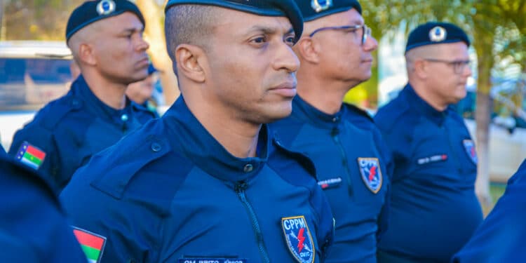 Guardas municipais em uniforme azul escuro perfilados durante cerimônia oficial