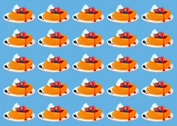 Desafio visual com várias panquecas decoradas com frutas e calda sobre fundo azul, onde uma delas é diferente e precisa ser encontrada rapidamente.