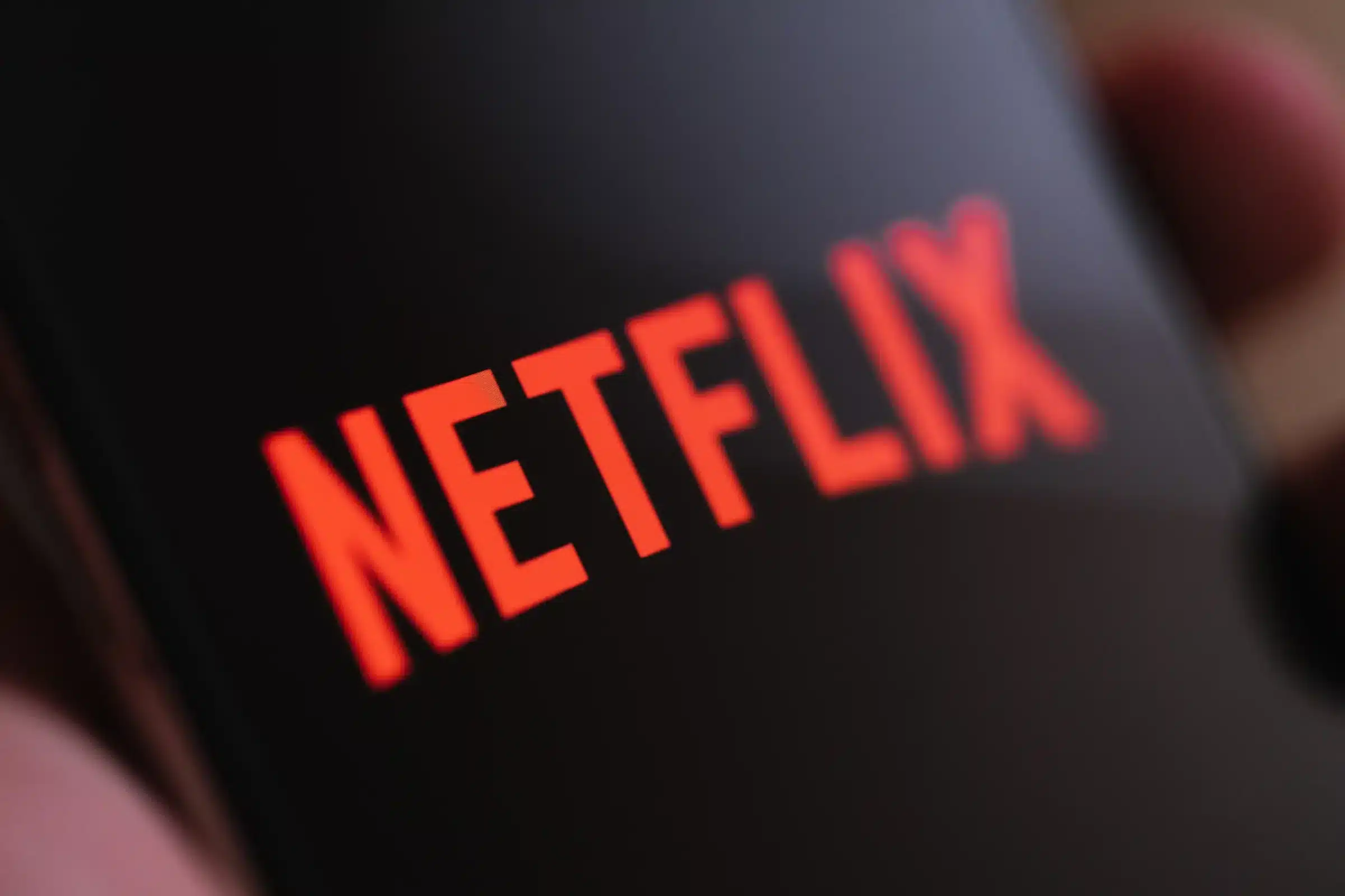 Logo da Netflix exibido na tela de um celular, representando mudanças de compatibilidade do aplicativo com dispositivos antigos.