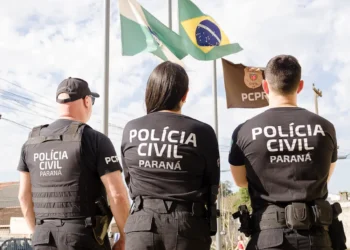 Policiais da Polícia Civil do Paraná posando em frente às bandeiras, representando atualizações sobre o concurso com três bancas na disputa.