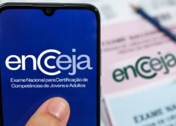 Celular exibindo tela do Encceja com destaque para prazo de justificativa de ausência e pedido de isenção da taxa 2026.