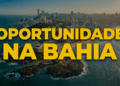Vista aérea do Farol da Barra com skyline de Salvador ao fundo e texto amarelo "Oportunidade na Bahia"
