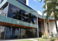 Concurso TCE RN 2026 - fachada do Tribunal de Contas do Estado do Rio Grande do Norte com bandeiras e palmeiras