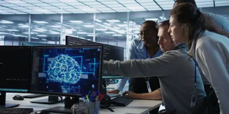 Equipe de profissionais analisando dados de inteligência artificial no ambiente de trabalho, com foco em crescimento de 642% no mercado de treinadores de IA no Brasil.