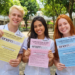 Estudantes exibem provas ENEM 2020 de cores diferentes no pátio escolar.