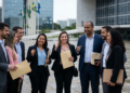 Equipe de profissionais comemora vitória em área externa.