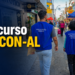 Dois fiscais do PROCON Alagoas com coletes azuis caminham em rua comercial movimentada durante operação de fiscalização