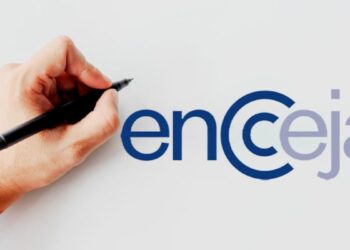 Mão segurando caneta preta ao lado do logotipo do Encceja em fundo branco com letras estilizadas