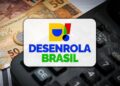 Logotipo do Desenrola Brasil sobre cédulas de real e calculadora preta