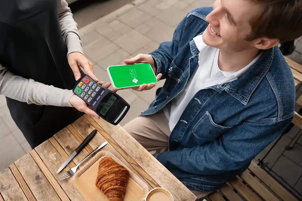 PIX por aproximação: usuários poderão ajustar limites de pagamento Cliente realizando pagamento por aproximação via PIX em maquininha, destacando ajuste individual de limites.