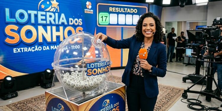 Mulher sorridente ao vivo mostra bola número 17 no sorteio da Loteria dos Sonhos, cenário azul