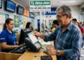 Homem idoso entrega bilhete da Mega-Sena atendente da Caixa em lotérica com faixa de prêmio acumulado