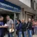 Fila de segurados em frente a uma agência do INSS, representando o atendimento extraordinário de serviços previdenciários.