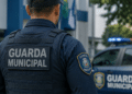 Guarda Municipal fardado de costas em frente a viatura oficial, representando o concurso da Guarda Municipal de Sobral (CE).