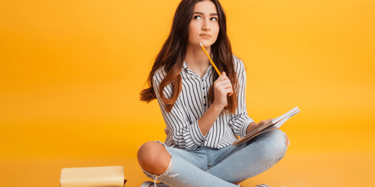 Jovem estudante com caderno e lápis se preparando para concursos de nível médio em 2026.
