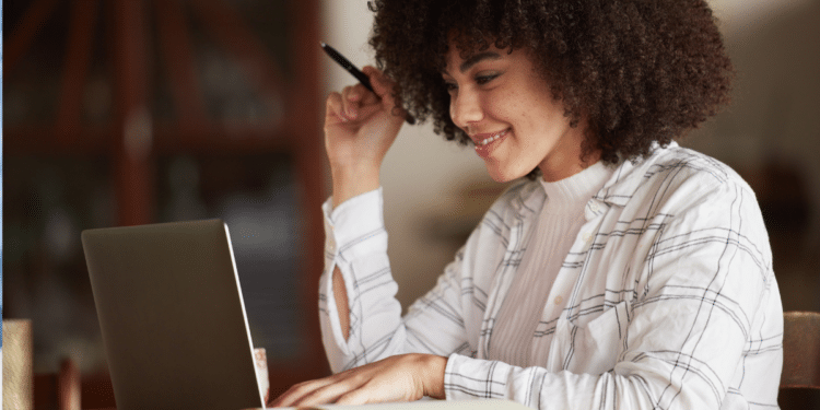 Mulher consulta vagas de concursos públicos em São Paulo pelo notebook.