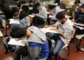 Estudantes fazendo prova em sala de aula, representando as provas do Enem 2026.