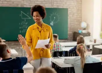 Professora em sala de aula durante atividade com alunos, representando a avaliação de docentes pela Prova Nacional Docente (PND) 2026.