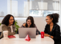 Três jovens reunidas no notebook em ambiente Bradesco ilustram as vagas do estágio Bradesco 2026