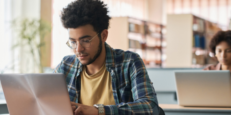 Pessoa estudando com notebook para concursos e oportunidades na área da educação.