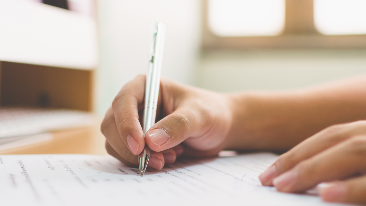 Candidato realiza prova de concurso público em sala de aplicação.